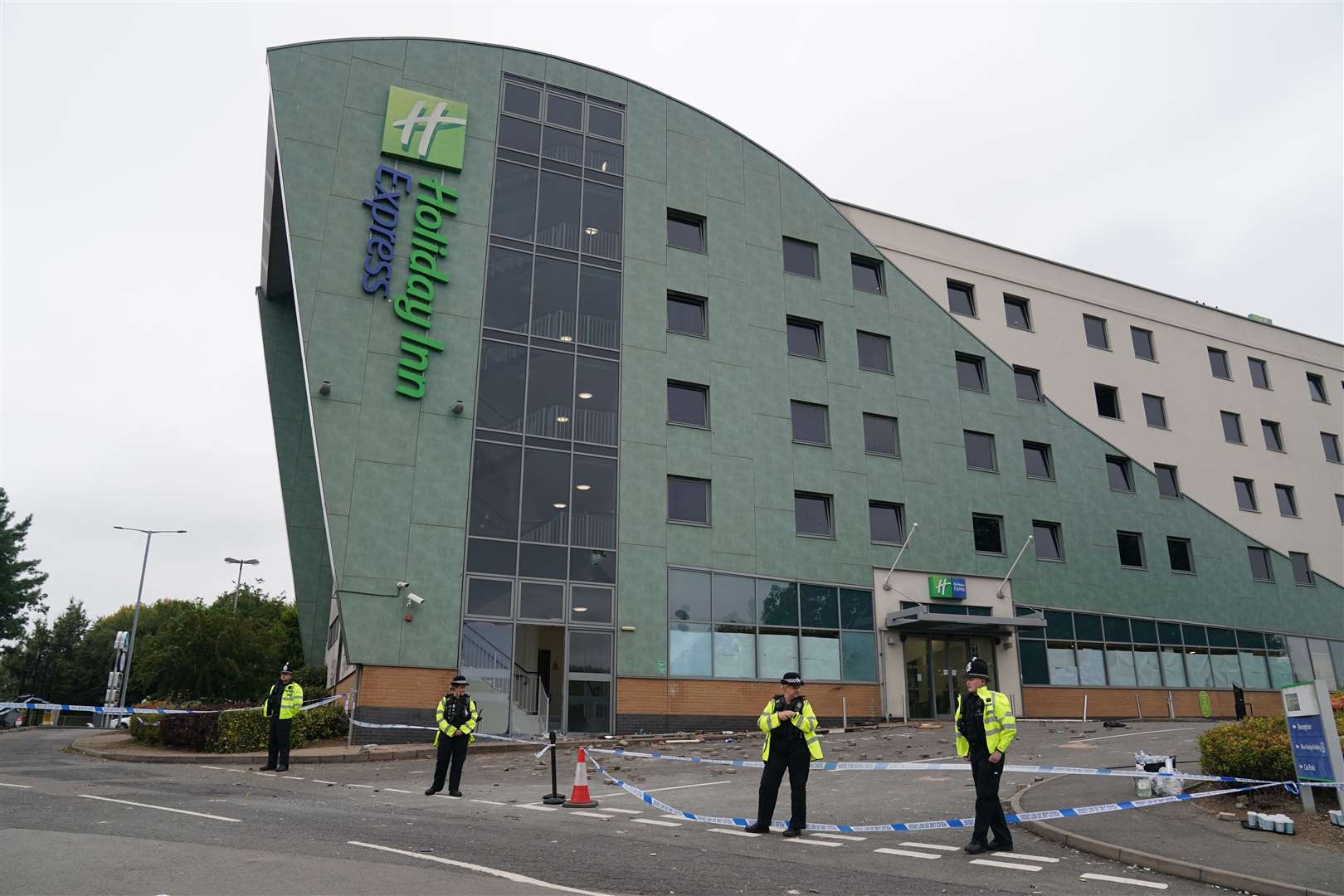 Police guarding the hotel after the riot (Jacob King/PA)