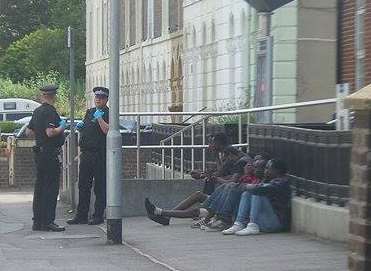The immigrants perched outside the station. Picture: Nathaniel Richards