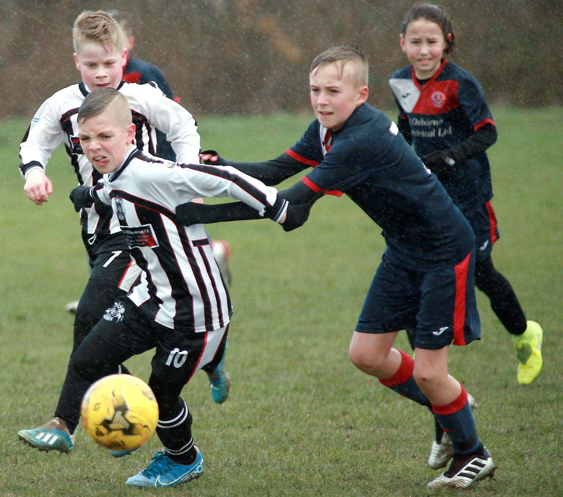 Hempstead Valley Colts under-11s (blue) battle it out against Milton & Fulston under-11s. Picture: Phil Lee FM31093491