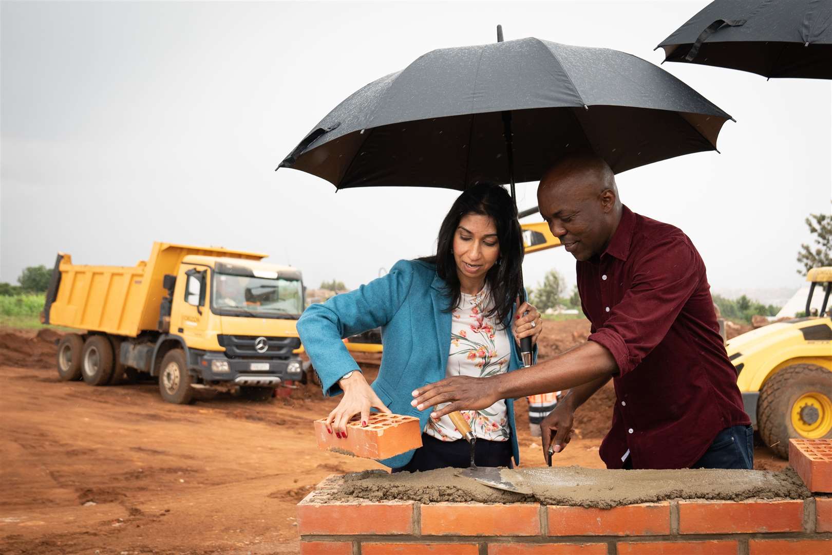 Ms Braverman attends a ground-breaking ceremony to mark the beginning of construction for a new building project of 500 apartments in Kigali (Stefan Rousseau/PA)