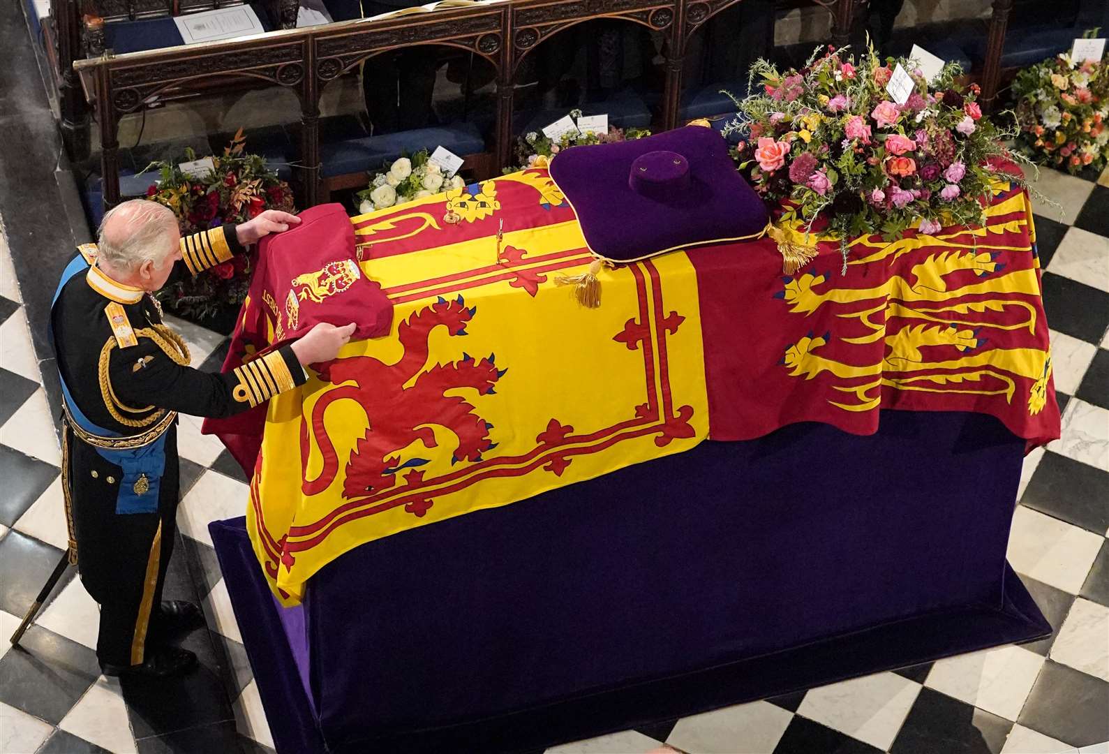 King Charles III places the Queen’s Company Camp Colour of the Grenadier Guards on the coffin at the Committal Service for Queen Elizabeth II (Jonathan Brady/PA)