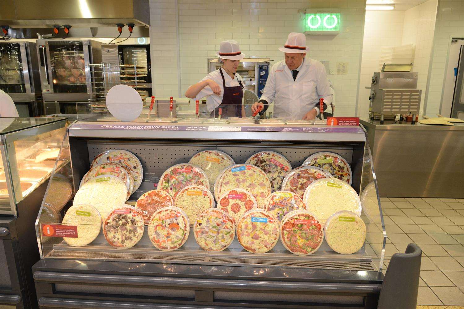 MP Damian Green working on the pizza counter with Sainbury's counters manager Grace Neeves