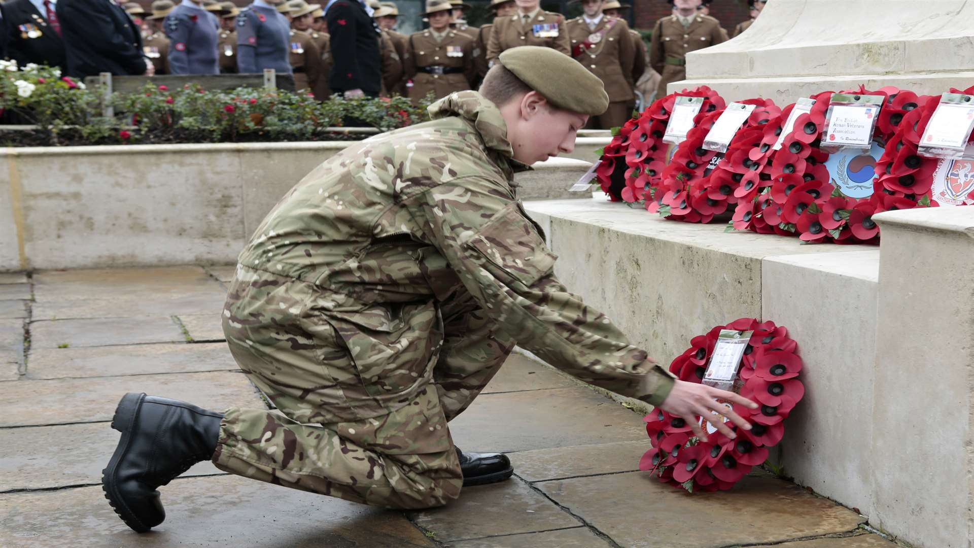 A cadet lays a wreath at the memorial near Maidstone West train station