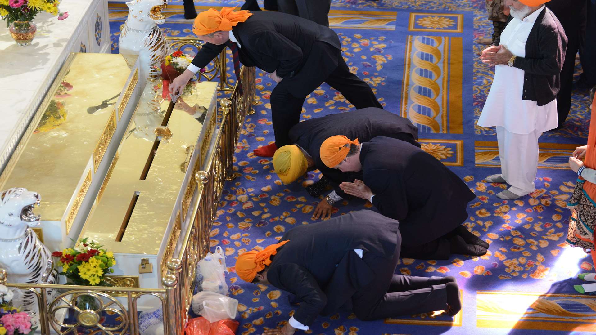 David Cameron (Centre) kneels at the altar in the Gurdwara at the Sikh festival of Vaisakhi in Gravesend Picture: Gary Browne