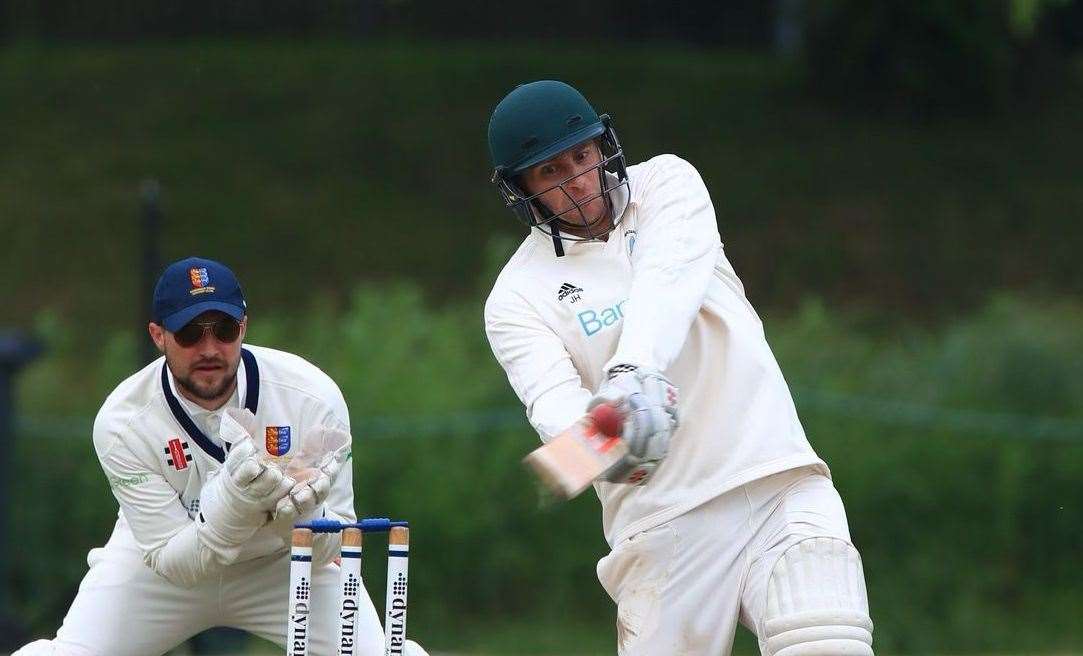 St Lawrence & Highland Court’s Jamie Hemphrey swings hard ahead of Sandwich Town wicketkeeper Ryan Davies on his way to a matchwinning 38 not out from 17 balls. Picture: Gary Restall