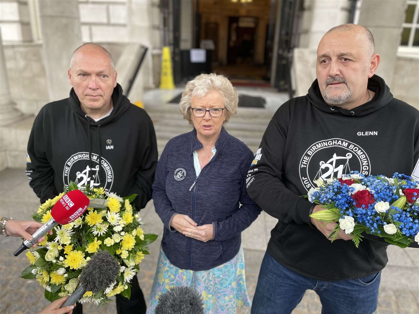 Ian Williams, Julie Hambleton and Glenn Randall outside Belfast City Hall (David Young/PA)