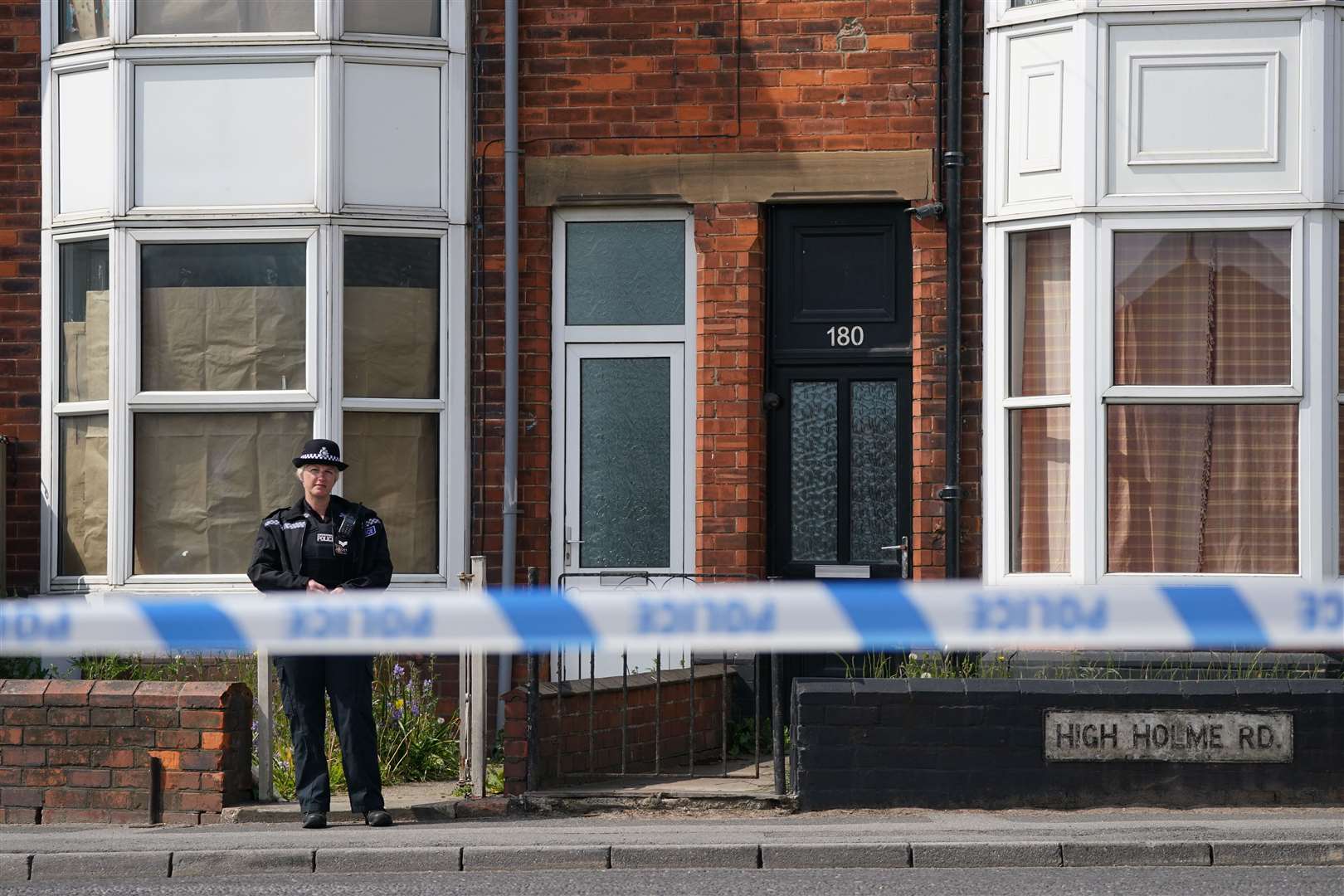 A police officer stood guard at the scene on Tuesday (Joe Giddens/PA)