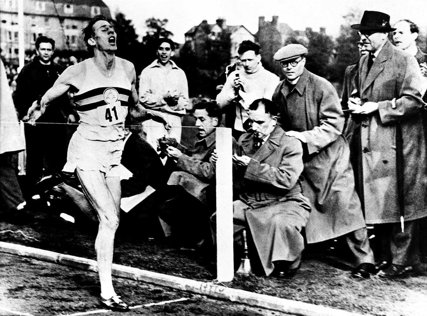 Roger Bannister completes the first mile in under four minutes in Oxford in 1954 (PA)