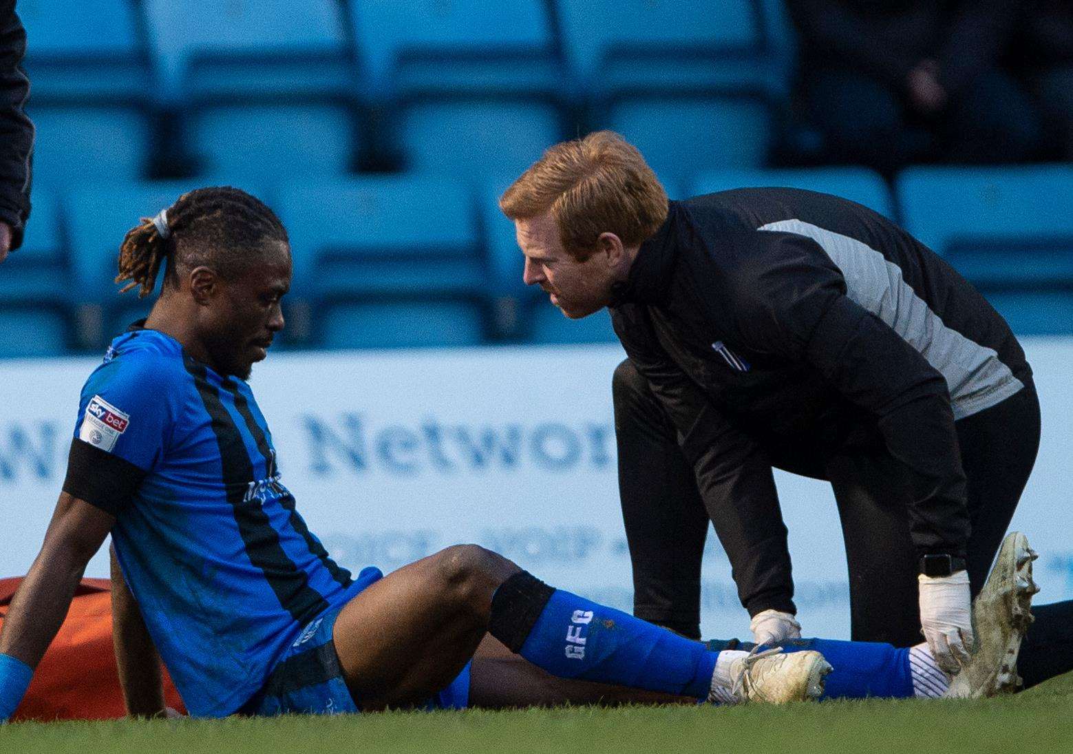 Physio Gary Hemens treats Gabriel Zakuani after suffering an ankle injury Picture: Ady Kerry