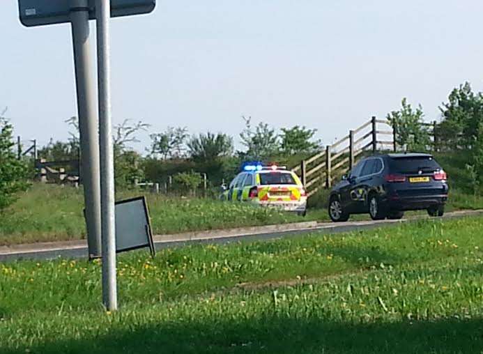 Police vehicles near the field