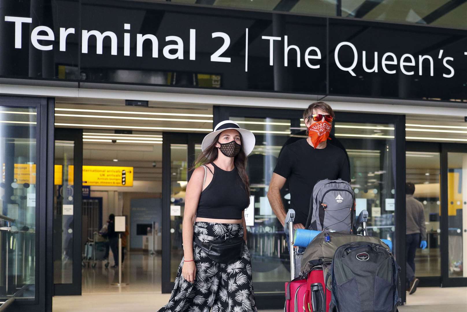 Guy Potter and Sarah Hartstein arrive at Terminal 2 at Heathrow Airport, as new quarantine measures for international arrivals come into force (Steve Parsons/PA)