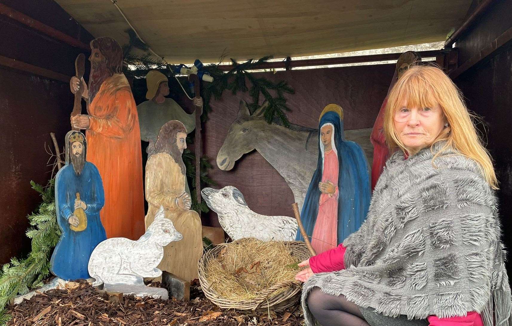 Susan Hopper, warden at All Saints Church points to the empty manger where baby Jesus should be. Picture: Joe Crossley