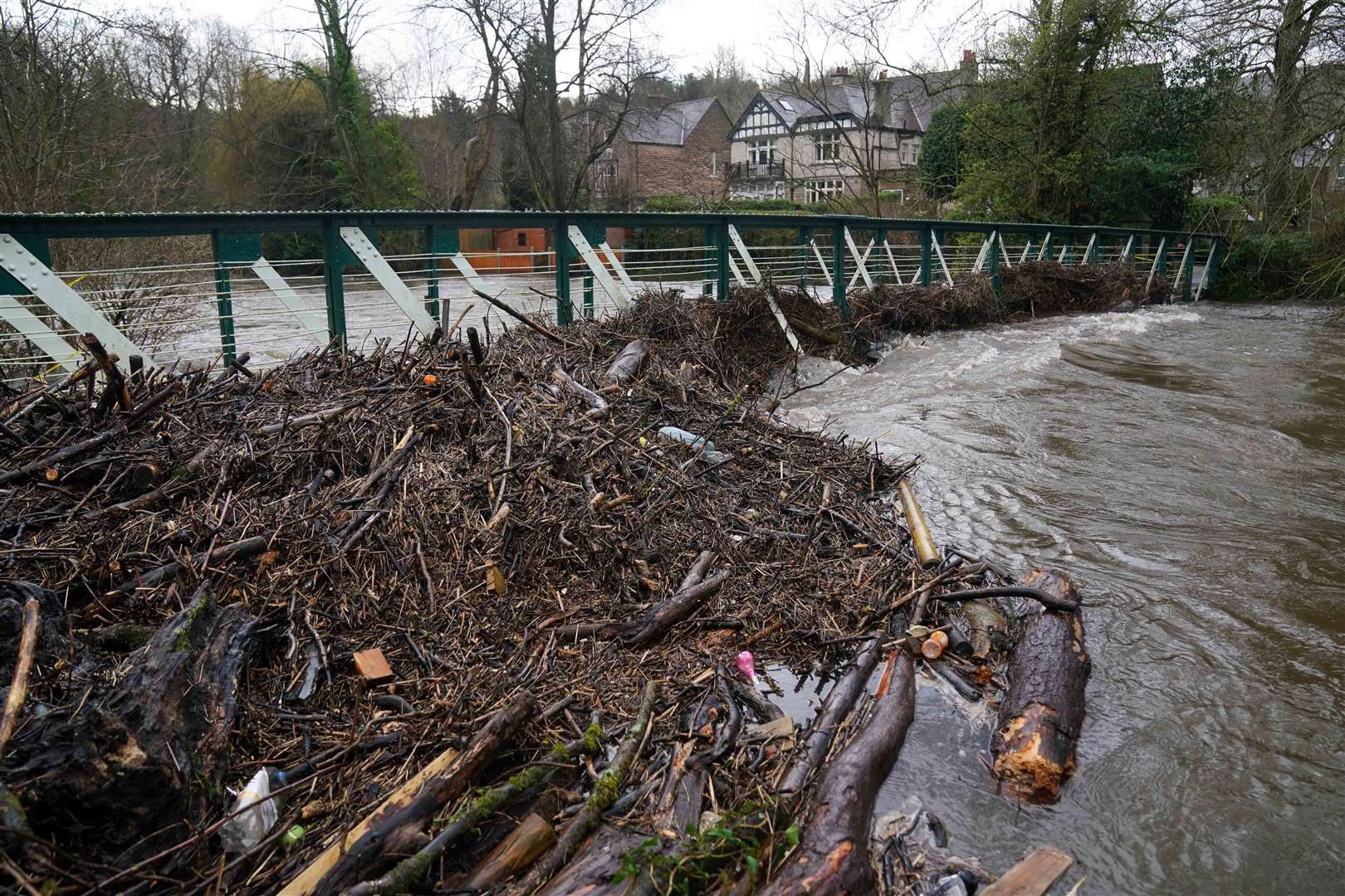 Debris gathers on the swollen River Derwent in Matlock (Jacob King/PA)