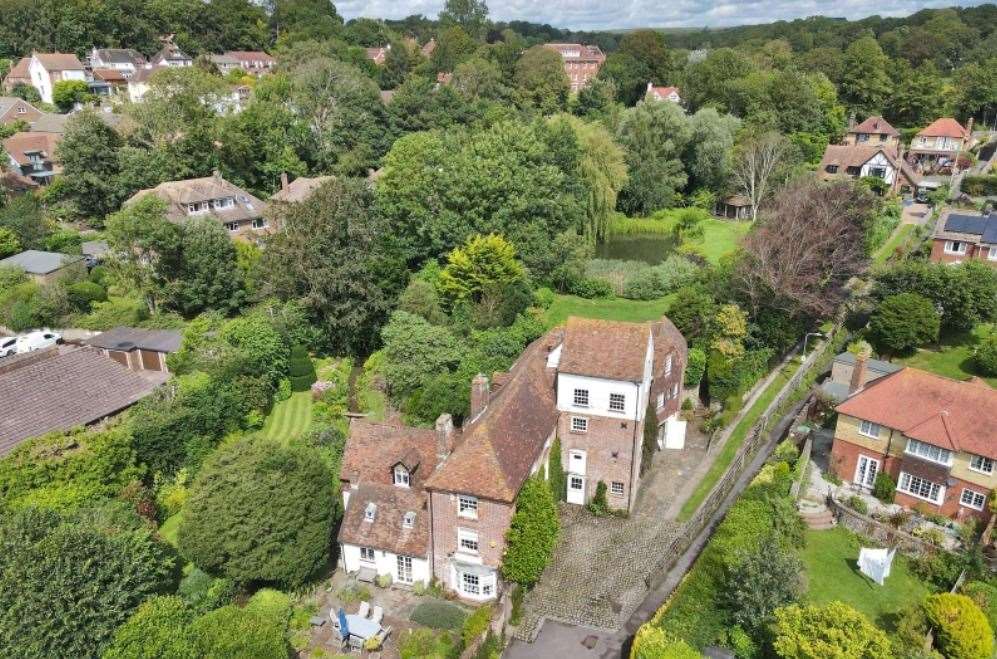 This huge property is surrounded by gardens, water features and lawns. Picture: Savills