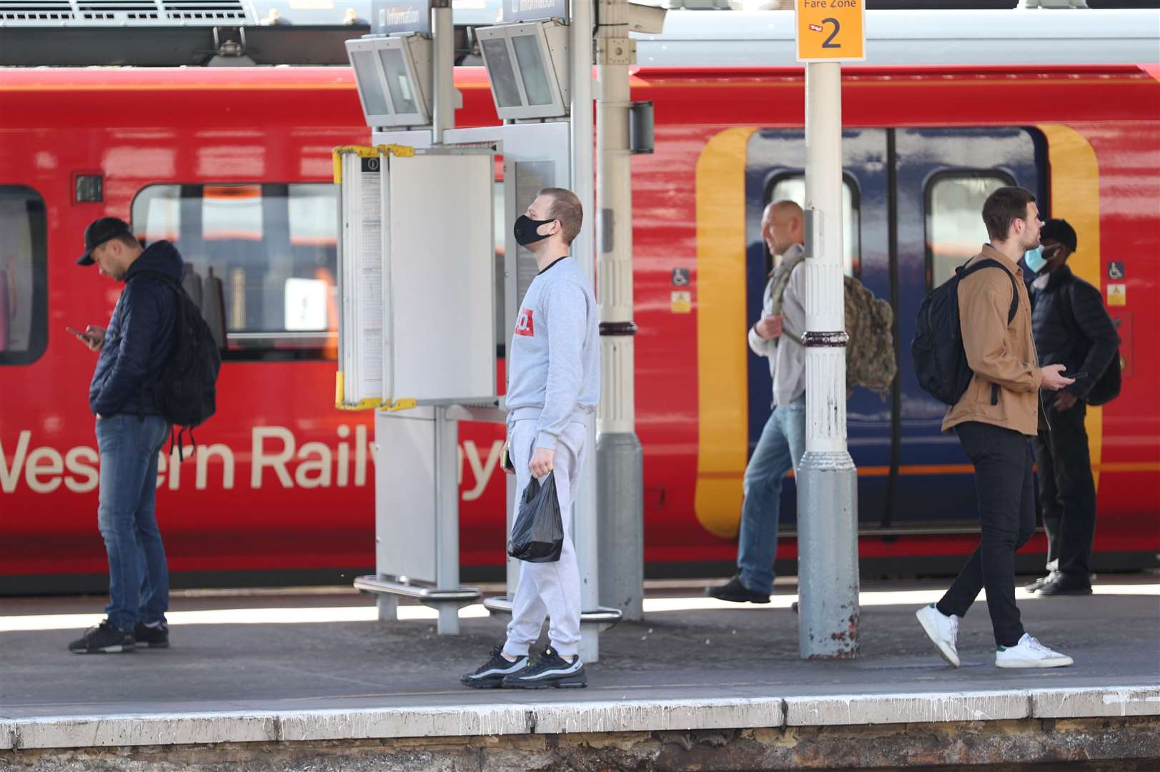 Passengers try to observe social distancing at Clapham Junction station (Yui Mok/PA)