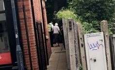 Brendan Rose walking an elderly lady home from the Sansbury's store in St Dunstan's. Picture: Paige Elizabeth (13110320)