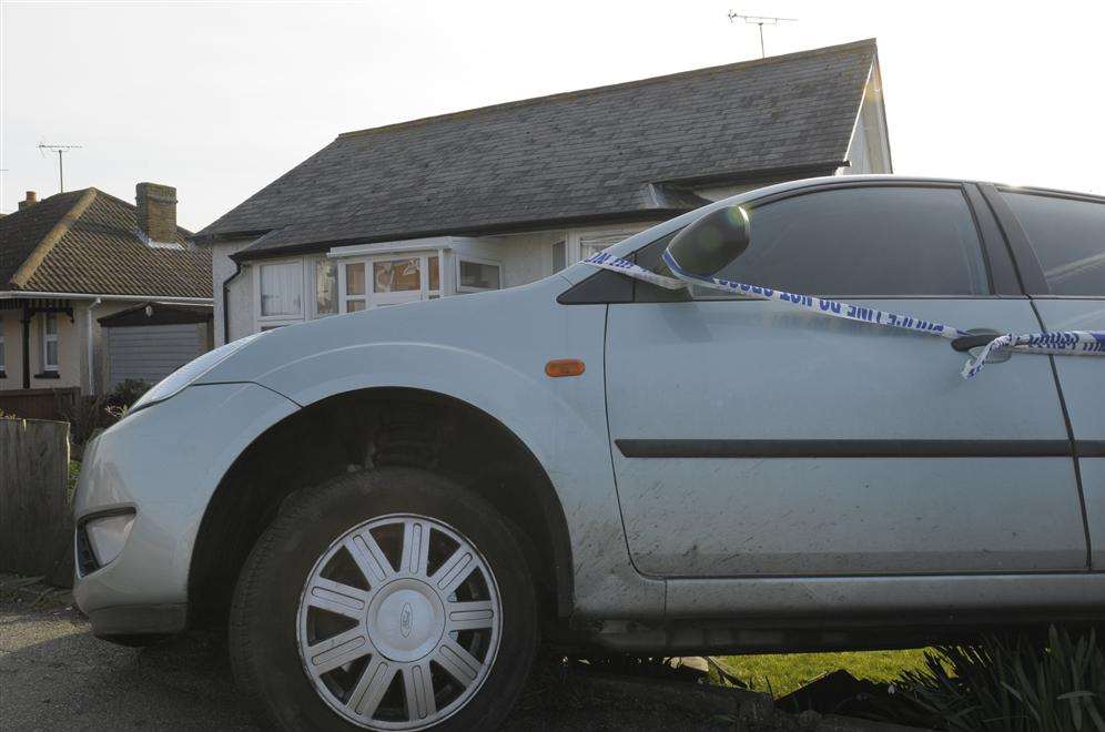 In a pickle, Mr Pearson's car was left wedged over a three-feet drop between the pavement and the lawn.