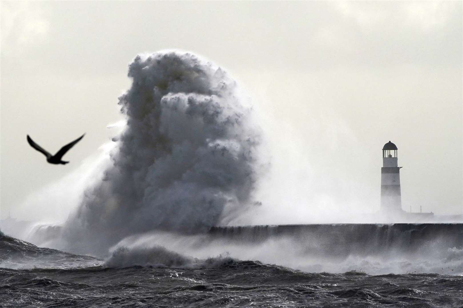 Wind combined with heavy rain in Co Durham led to large waves crashing against the lighthouse in Seaham Harbour (Owen Humphreys/PA)