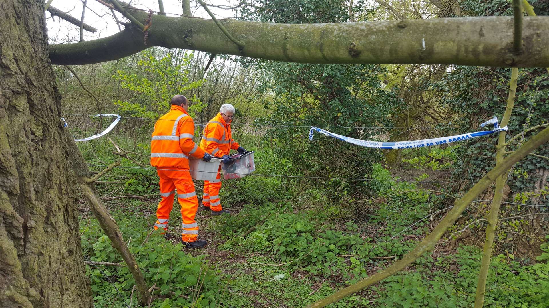 Serco workers recover belongings from the scene