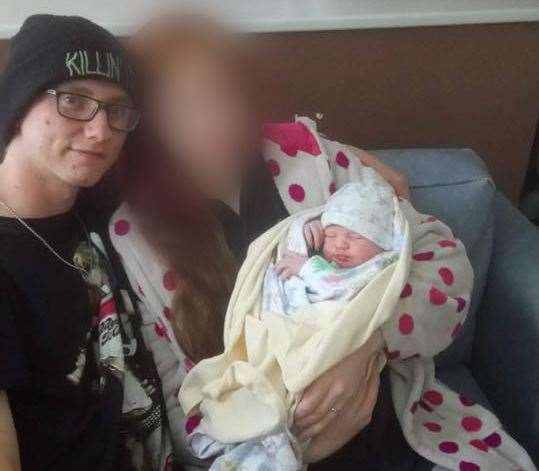 Lee Vernon, wearing a 'KILLIN' IT' hat, is pictured with McKenzie and mum, Katrina, in hospital