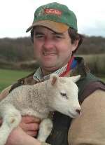 Farmer Guy Lister with one of the surviving lambs. Picture: GARY BROWNE