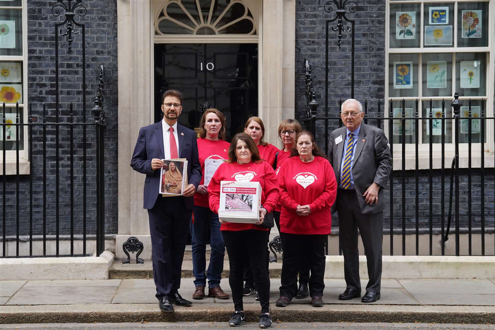 Bereaved families with MPs Sir Peter Bottomley (right) and Afzal Khan (left) deliver a petition to 10 Downing Street, London (Stefan Rousseau/PA)