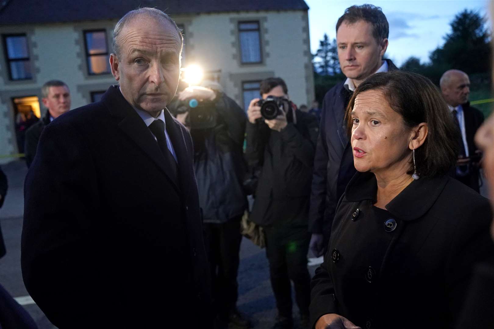 Taoiseach Micheal Martin speaks to Sinn Fein leader Mary Lou McDonald at the scene (Brian Lawless/PA)