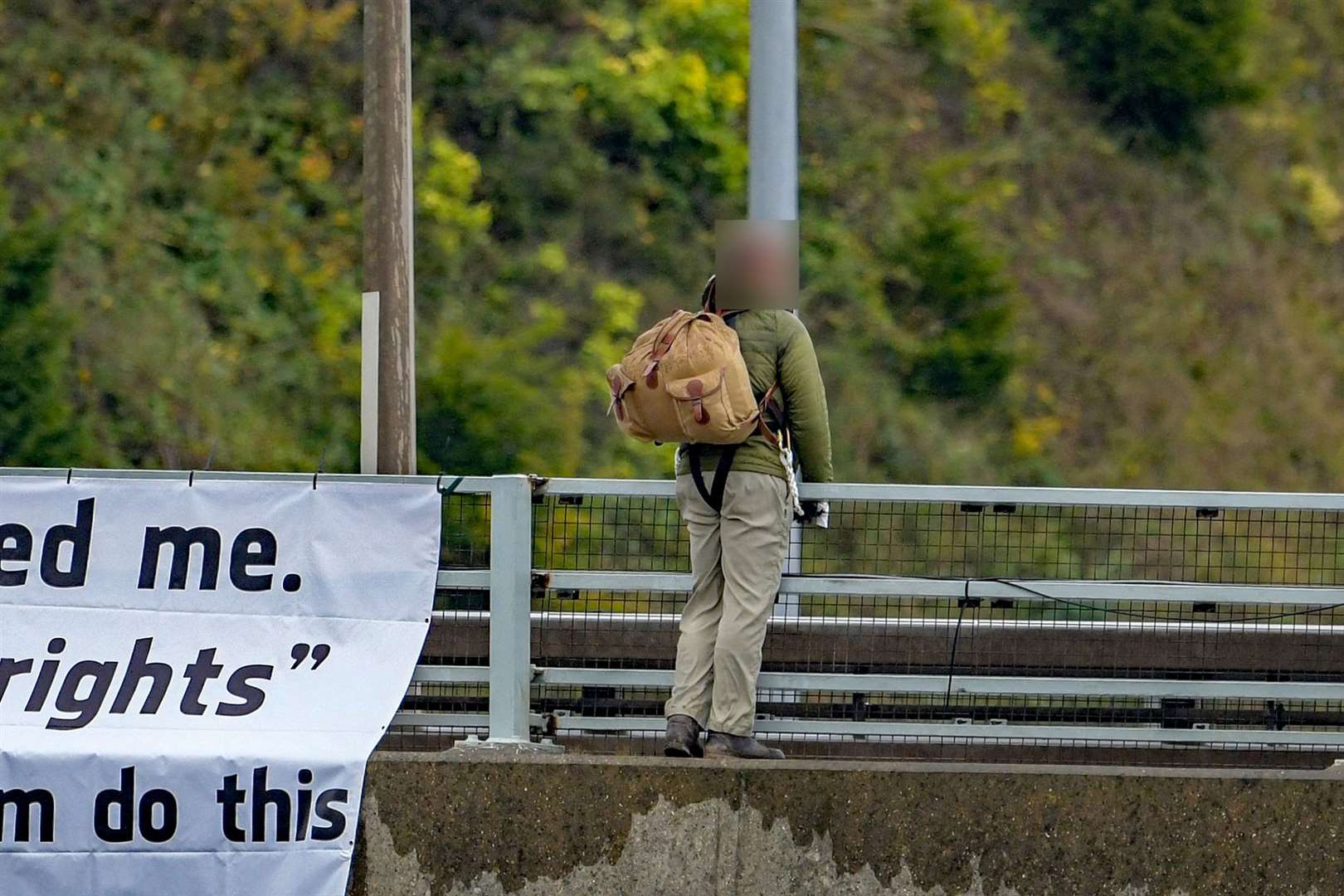 A man appears to have tied himself to the bridge. Photo: Stuart Brock Photography