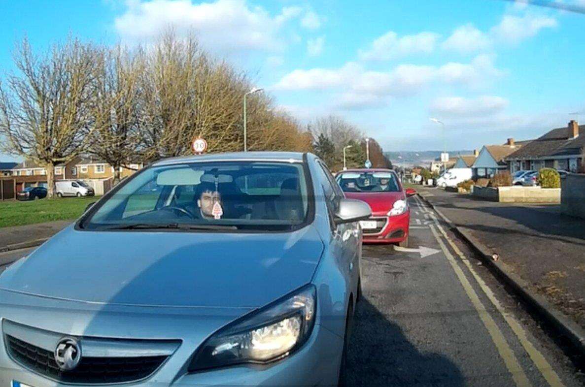 A driver is seen to throw a coffee cup and a bottle from his car (6816206)