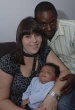 MacKenzie Haynes, who weighed 11lbs at birth, with his dad Julian and mum Trina Clark