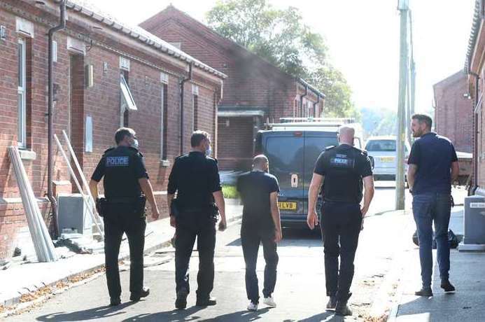 Police officers are escorted around Napier Barracks. Picture: (Gareth Fuller/PA)