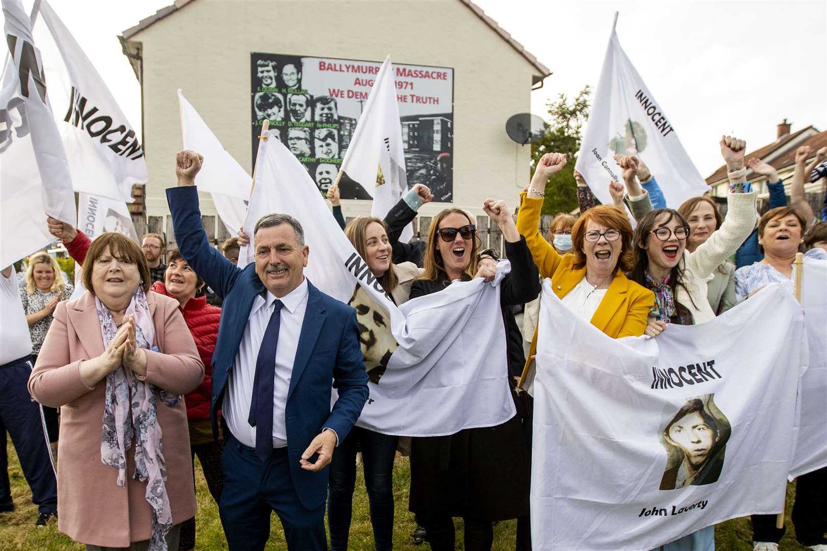 The families of the Ballymurphy victims and supporters wave white flags hours after a coroner ruled that the 10 people killed in the west Belfast shootings involving British soldiers in Ballymurphy in August 1971 were entirely innocent (Liam McBurney/PA)