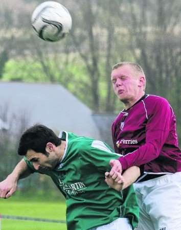 City's Dan Bonneywell wins this aerial battle against Staplehurst