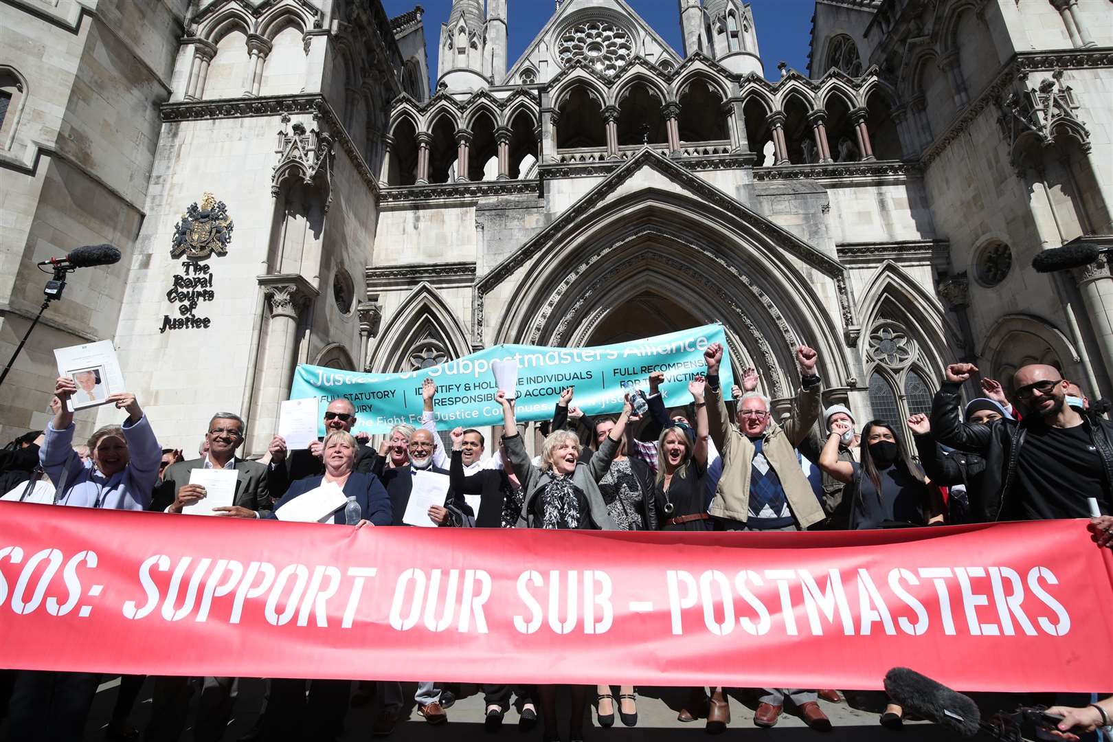 Former post office workers celebrate outside the Royal Courts of Justice in London after having their convictions overturned by the Court of Appeal (Yui Mok/PA)