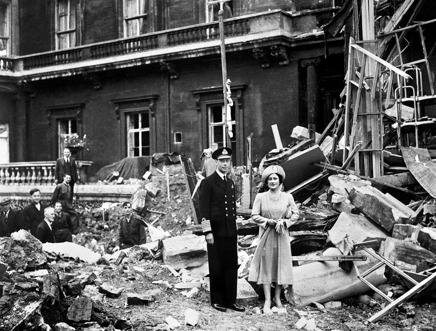 King George VI and the Queen Mother survey bomb damage at Buckingham Palace – care home residents told William and Kate about air attacks they had suffered (PA)