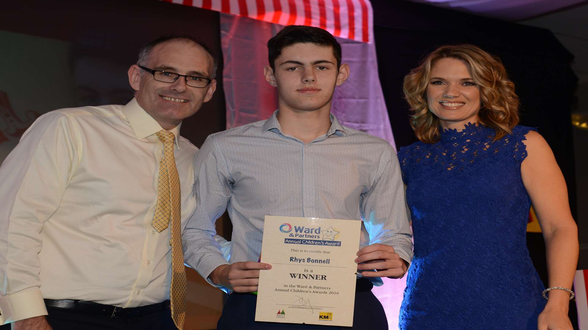 Charlotte Hawkins and Arun Estates Lettings Director Jason Bunning presenting the Going For Gold award to Rhys Bonnell