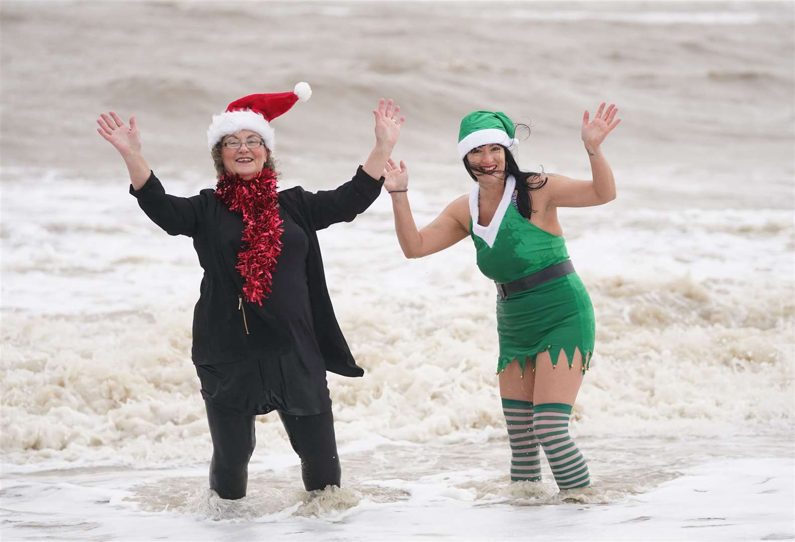 Swimmers in fancy dress pose in the sea at Felixstowe (Joe Giddens/PA)