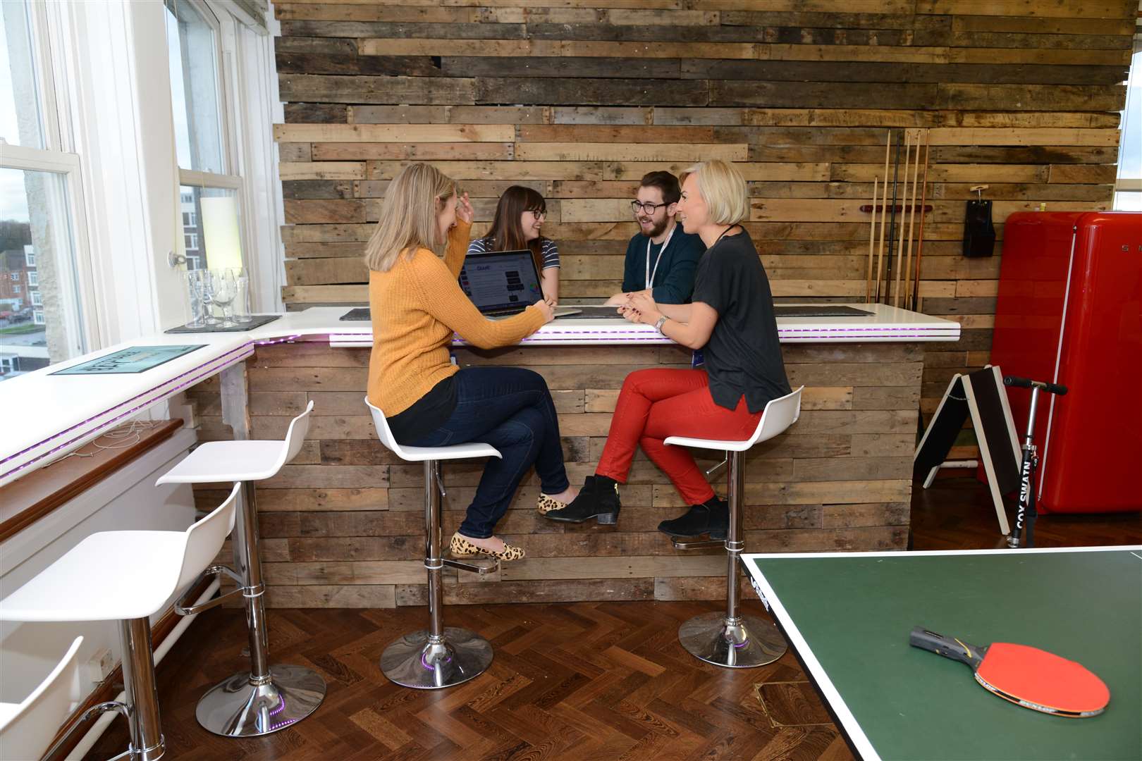 Staff at Sleeping Giant Media can work and rest at a breakfast bar with sea views