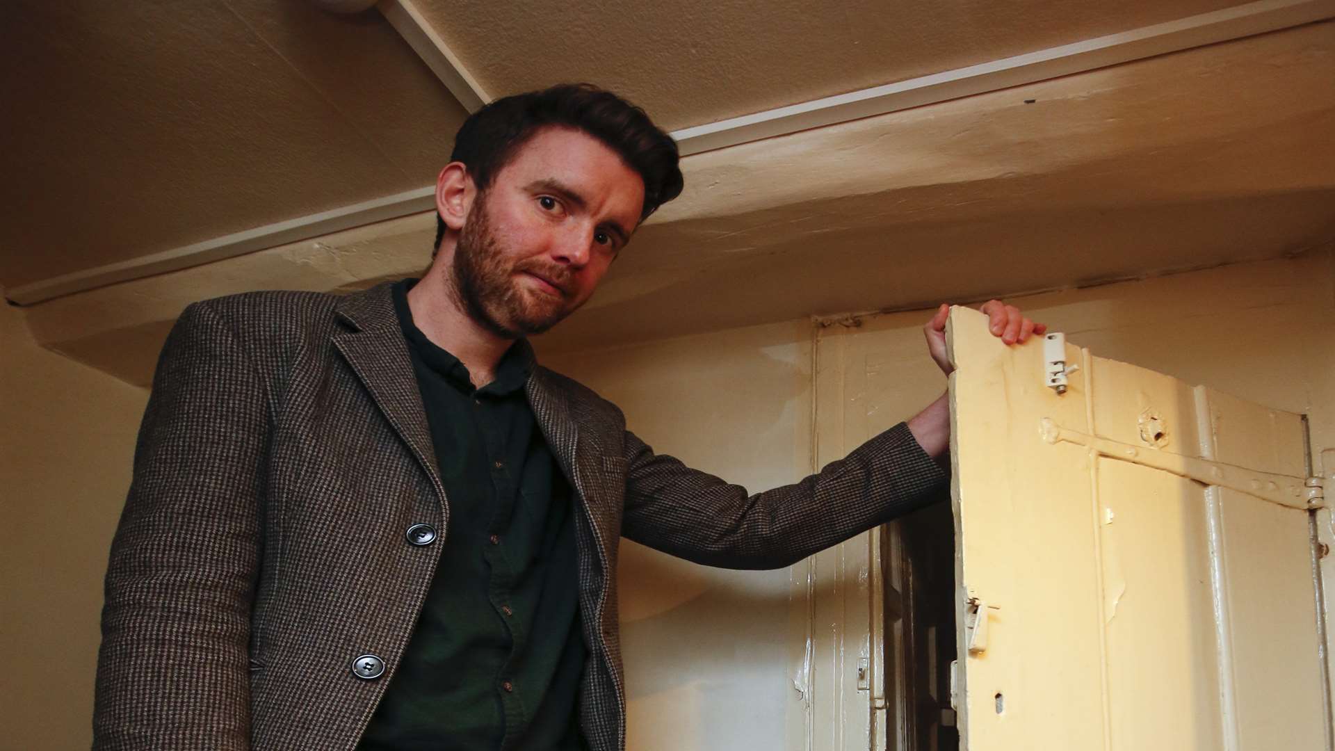 Joe O'Donnell upstairs in the pub with a very old small door. Picture: Martin Apps.