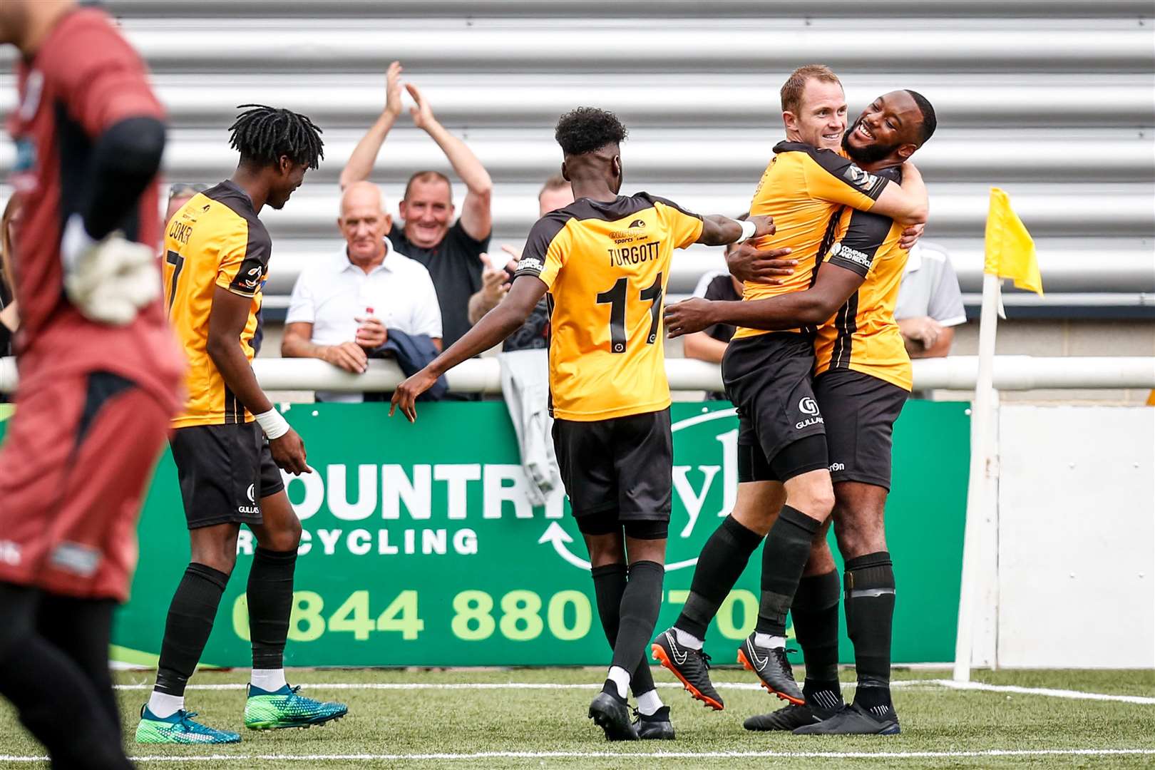 Shamir Mullings celebrates his goal with captain Stuart Lewis and Blair Turgott Picture: Matthew Walker