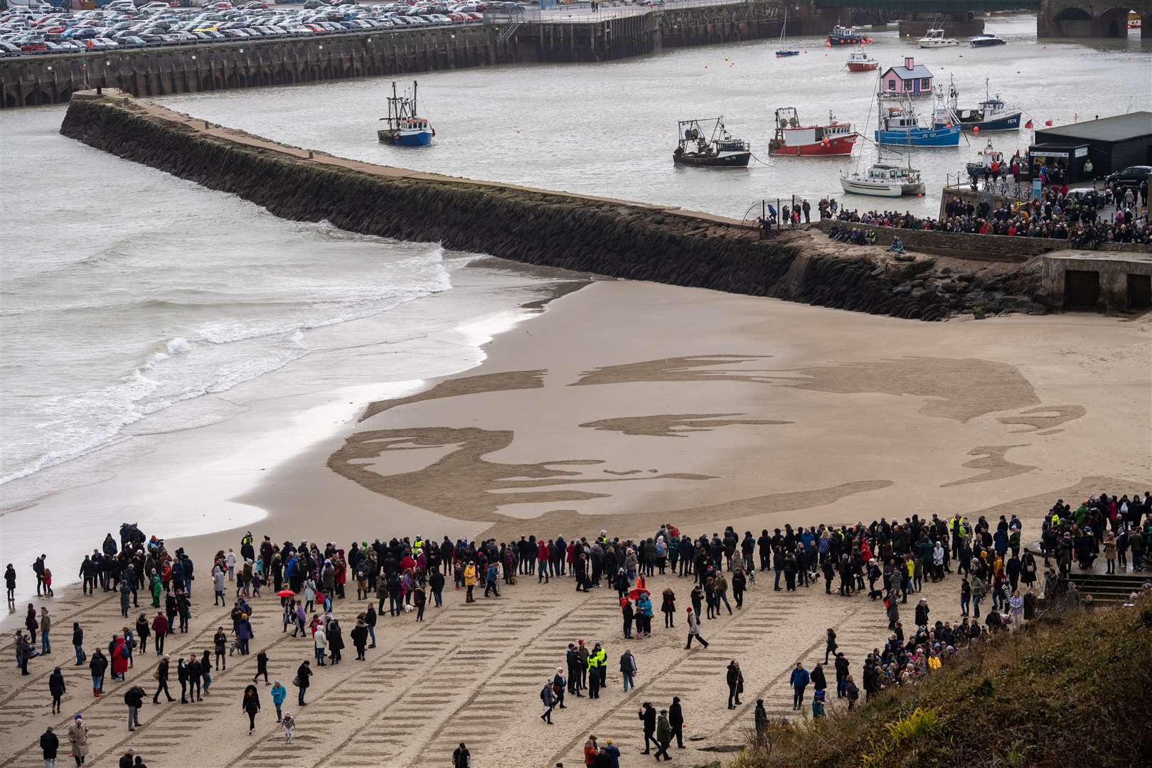 Wilfred Owen's portrait on the beach is gently erased by the lapping waves Picture: Getty Images/ Chris J Ratcliffe