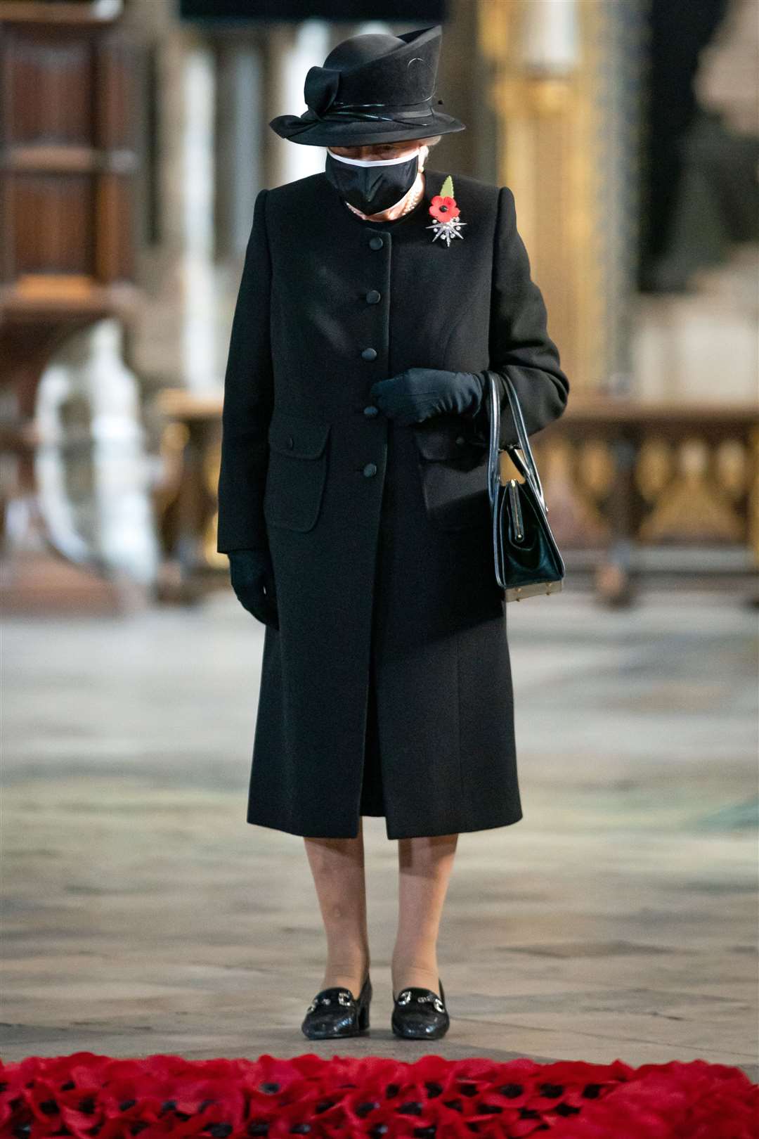 In November the Queen wore a face mask during a ceremony to mark the centenary of the burial of the Unknown Warrior at Westminster Abbey (Aaron Chown/PA)