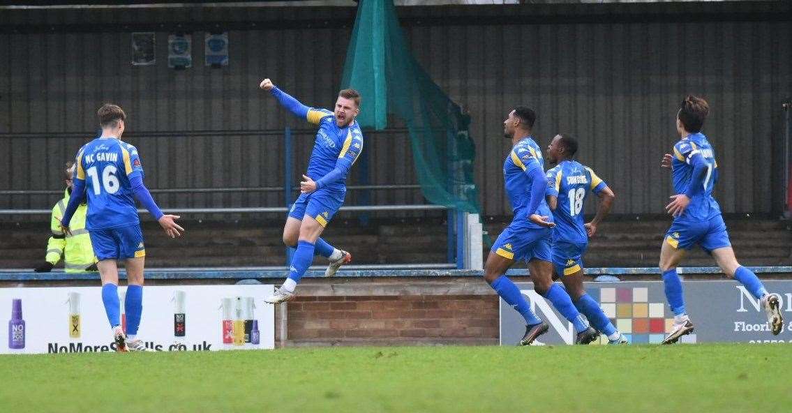 Two-goal Joshua Barrett celebrates his opening strike for King's Lynn against Dover. Picture: Tim Smith