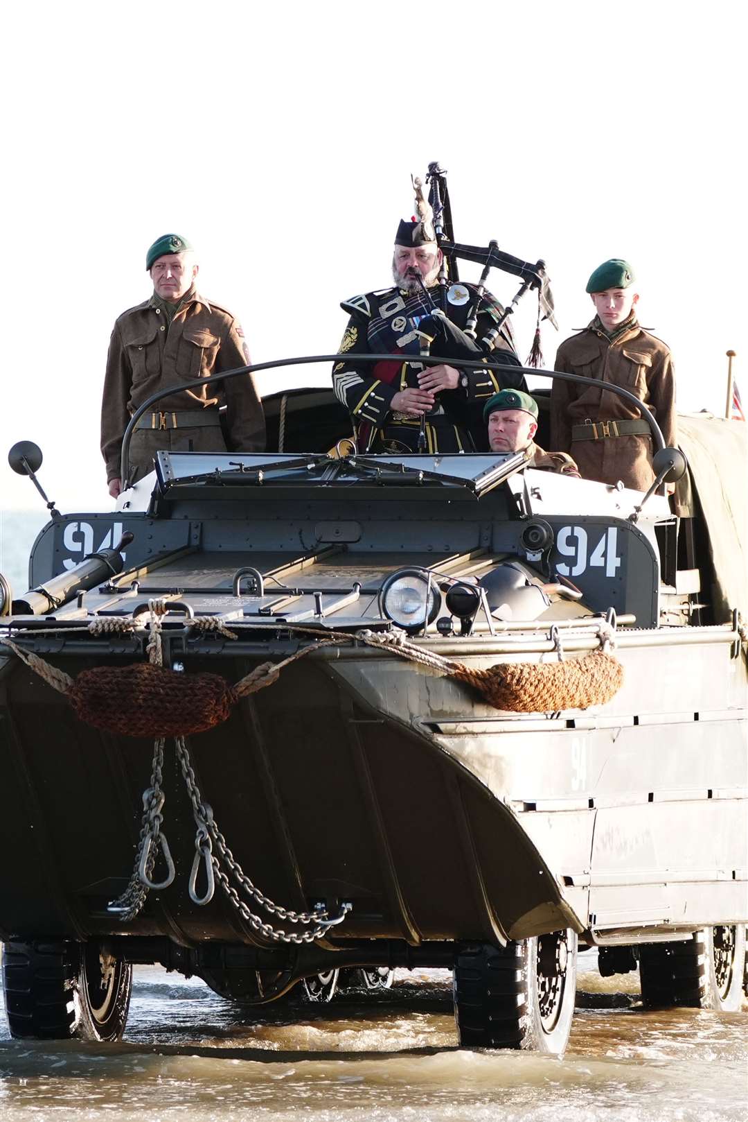 Military piper Major Trevor Macey-Lillie comes onto shore on a DUKW amphibious vehicle at Gold Beach in Arromanches in Normandy (Aaron Chown/PA)