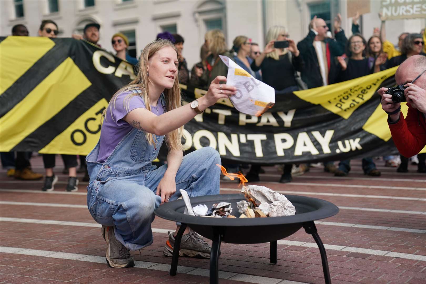 A protester takes part in an ‘energy bill burning’ in Birmingham (Jacob King/PA)