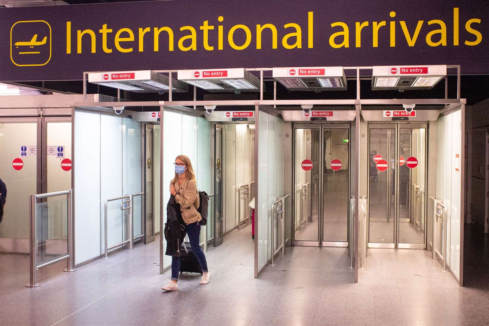 A passenger arrives at Gatwick Airport, following the Government’s quarantine ruling on Spain (Dominic Lipinski/PA)