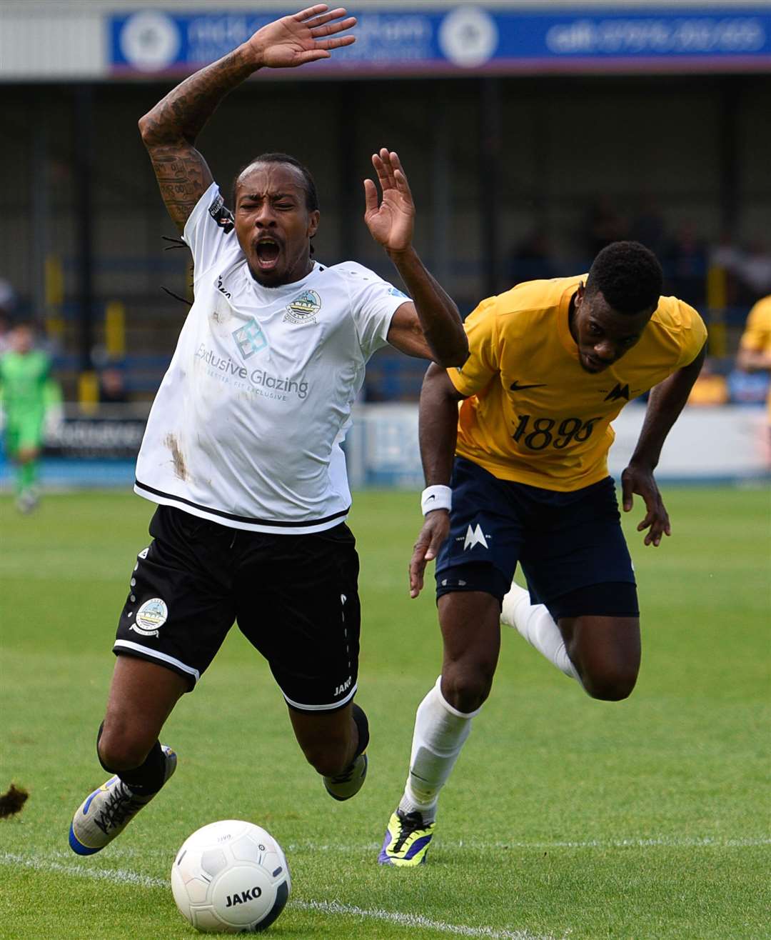 Dover's Ricky Modeste is sent sprawling by Torquay's Jean Yves Koue Niate. Dover wanted a penalty but referee Alan Dale awarded a free-kick Picture: Alan Langley