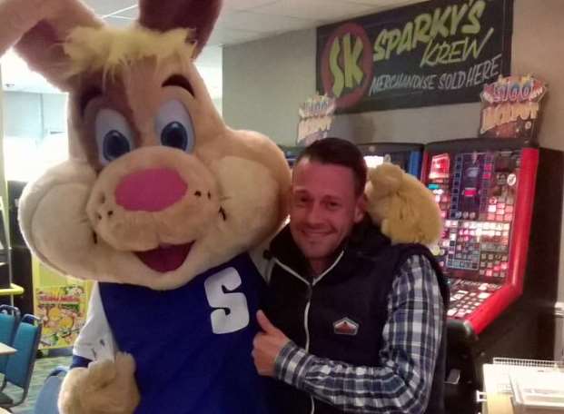 Matthew Gillett having fun Sparky, a holiday park resort mascot.