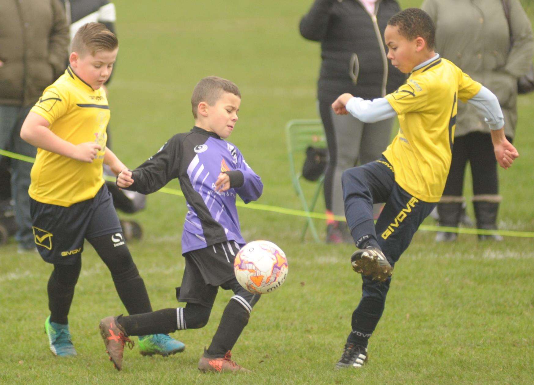 Anchorians Jaguars under-9s (purple) and Sheerness East Youth fight for the ball Picture: Steve Crispe