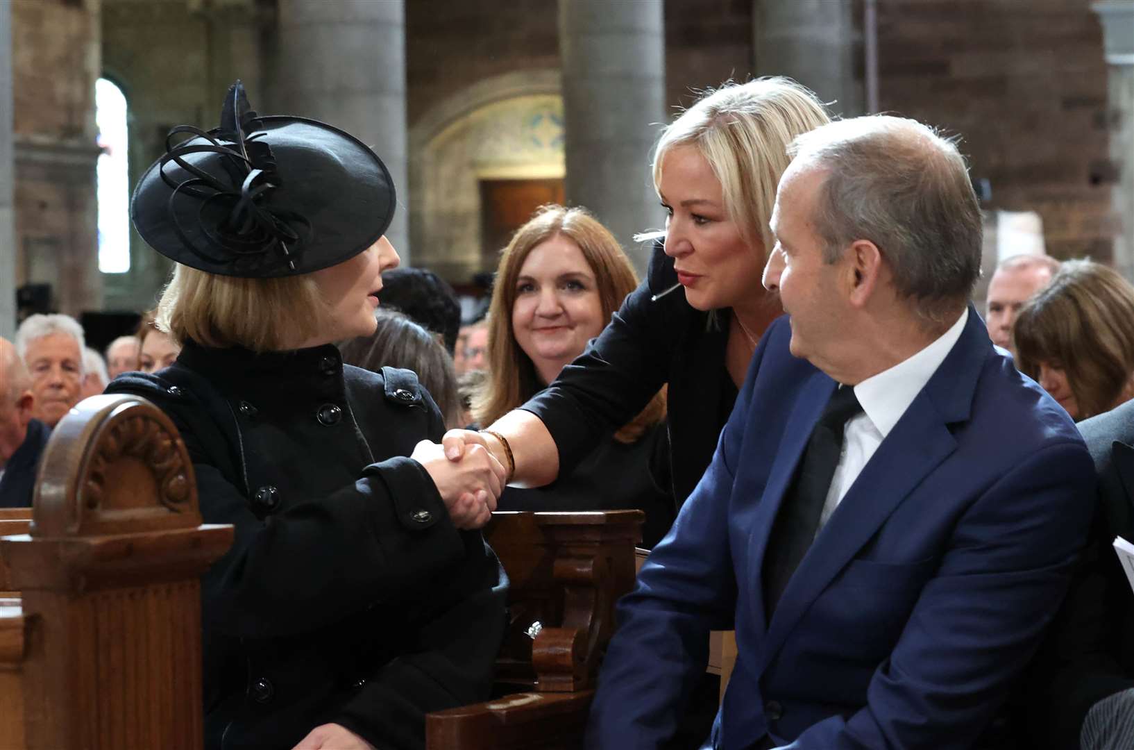 Prime Minister Liz Truss greets Sinn Fein vice president Michelle O’Neill as Taoiseach Micheal Martin looks on (Liam McBurney/PA)